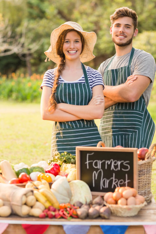 Happy vendors for a local community farmers market.